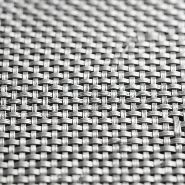 Close-up of a tightly woven stainless steel mesh filter showing its intricate and durable structure for effective filtration.
